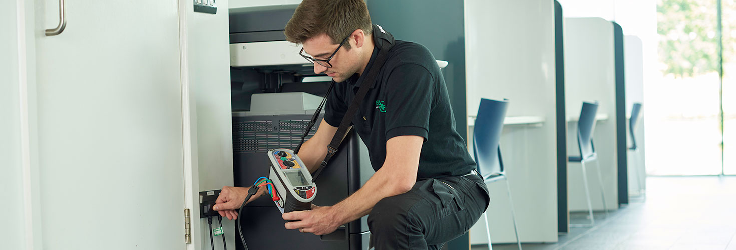 ECS Electrician Using Currant Reader Machine to analyse the volts and amps from an outlet