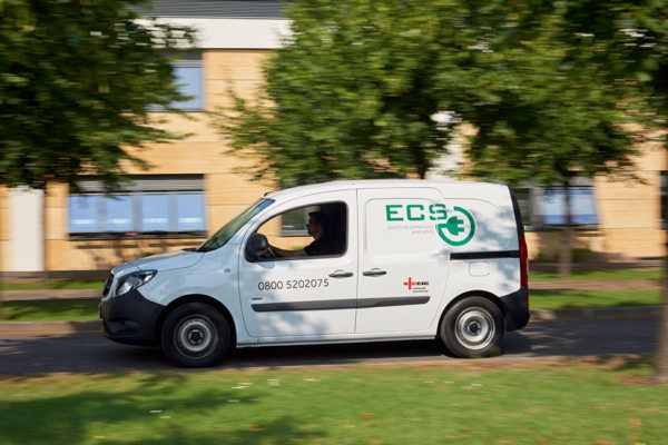 ECS Van with branding driving Side View