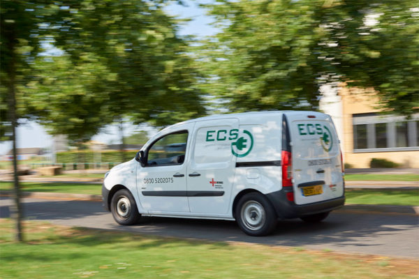 ECS work van driving through estate with branding along sides and back